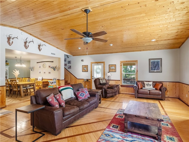 living room featuring ceiling fan with notable chandelier, wooden ceiling, lofted ceiling, light hardwood / wood-style flooring, and wooden walls