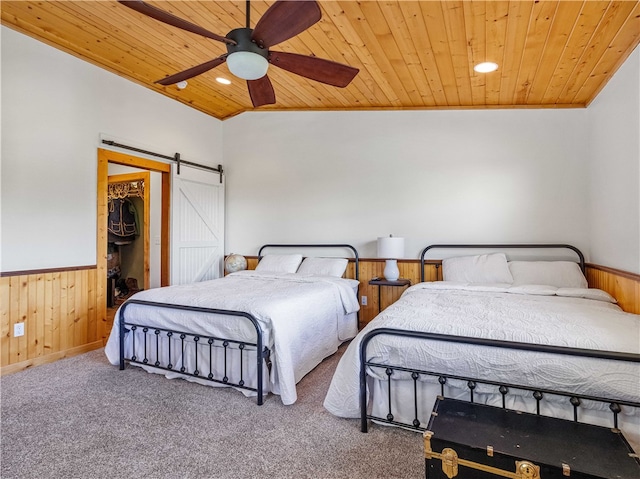 bedroom featuring a barn door, wood ceiling, vaulted ceiling, and ceiling fan