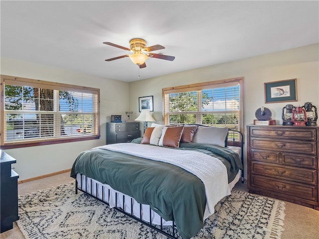 bedroom with light carpet and ceiling fan