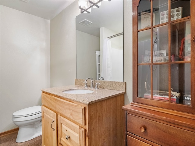 bathroom with vanity, toilet, and tile patterned floors