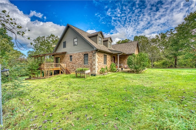 rear view of property with a lawn and a deck