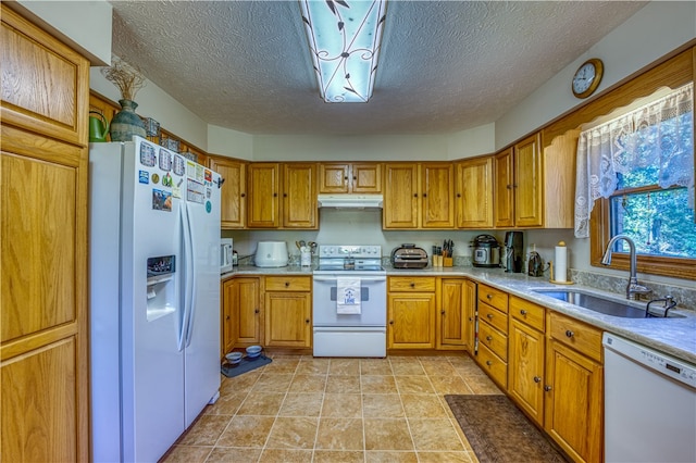 kitchen featuring light tile patterned floors, a textured ceiling, sink, and white appliances