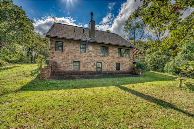 back of property featuring a lawn