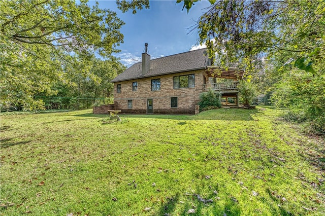 rear view of property with a lawn