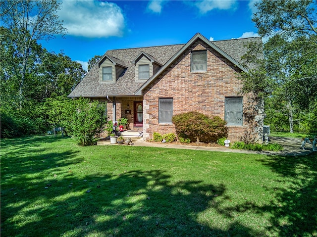 cape cod-style house with a front lawn