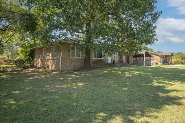 view of property hidden behind natural elements with a front lawn