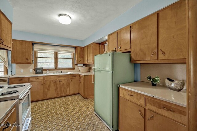 kitchen featuring sink and white appliances