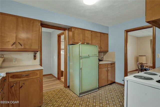 kitchen with white appliances and light hardwood / wood-style floors