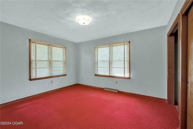 spare room featuring a healthy amount of sunlight and carpet flooring