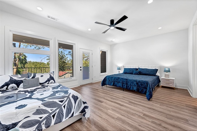 bedroom with light hardwood / wood-style floors, ceiling fan, and access to outside