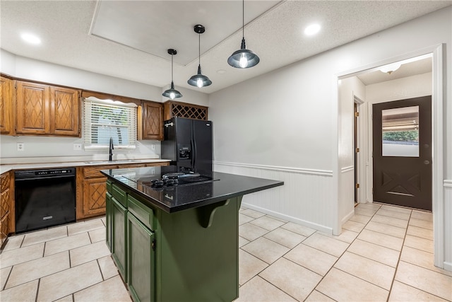 kitchen featuring black appliances, plenty of natural light, a center island, and sink