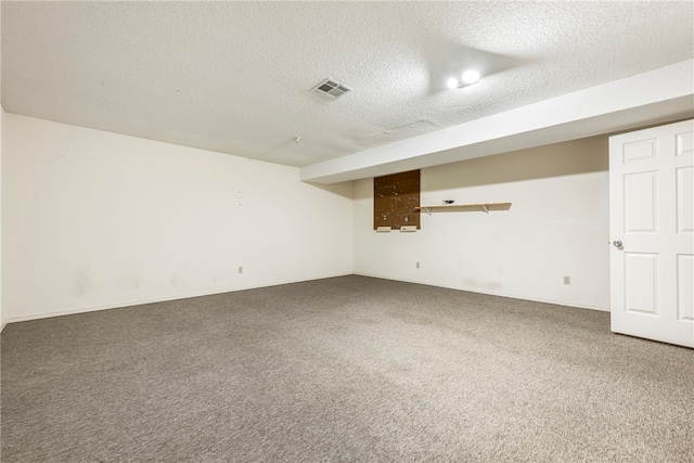 spare room with carpet and a textured ceiling