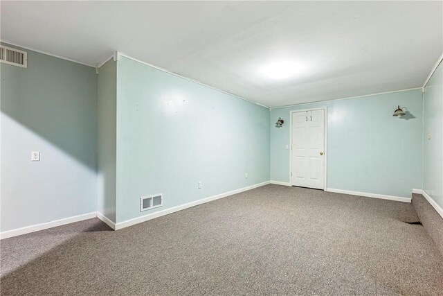 unfurnished room with ornamental molding and carpet floors