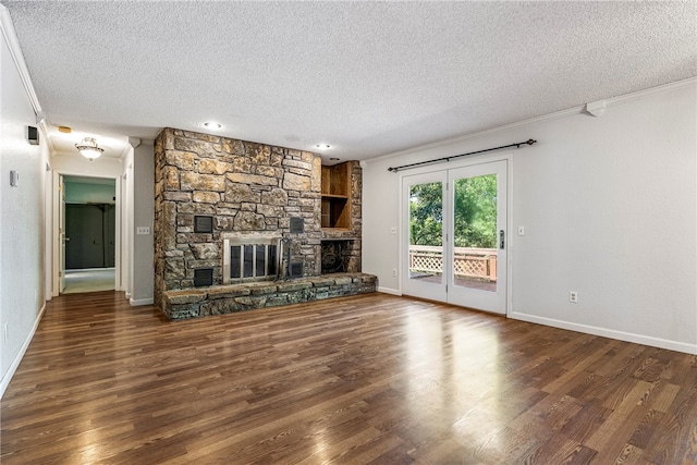 unfurnished living room featuring a textured ceiling, dark hardwood / wood-style floors, and a stone fireplace