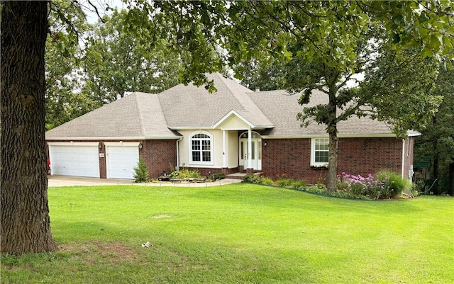 ranch-style house with a garage, brick siding, and a front yard