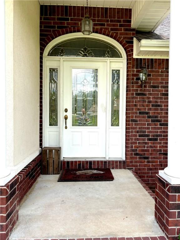 property entrance featuring brick siding