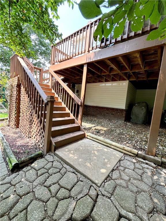 view of patio featuring stairway and a wooden deck