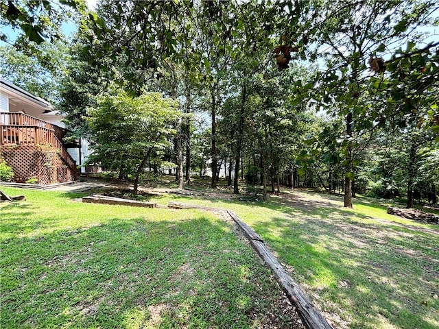 view of yard with a deck and stairway