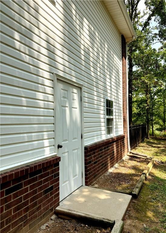 property entrance featuring brick siding