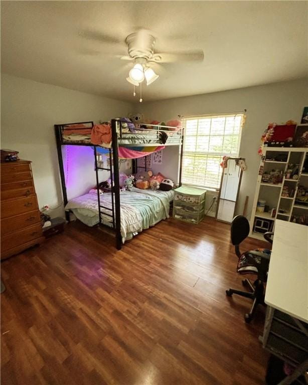 bedroom with a ceiling fan and wood finished floors