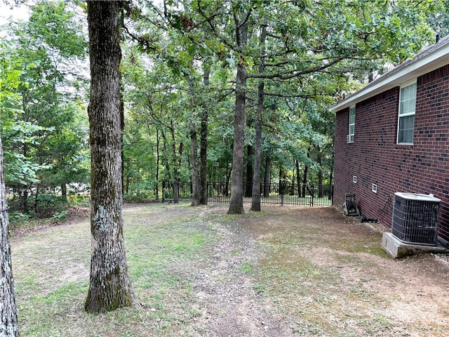 view of yard featuring cooling unit and fence