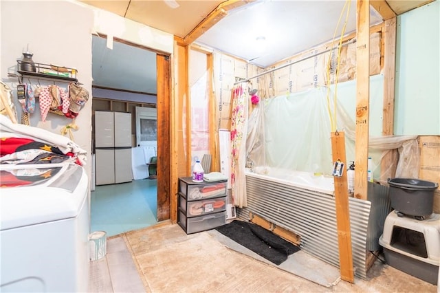 bathroom featuring washer / dryer and shower / bath combo