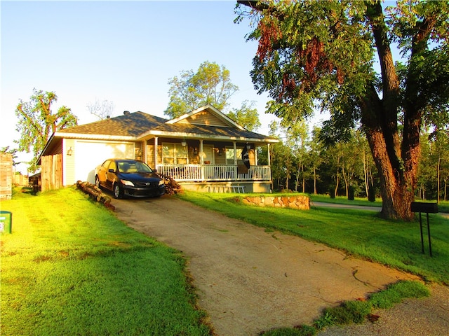 view of front of property with a front yard, a porch, and a garage