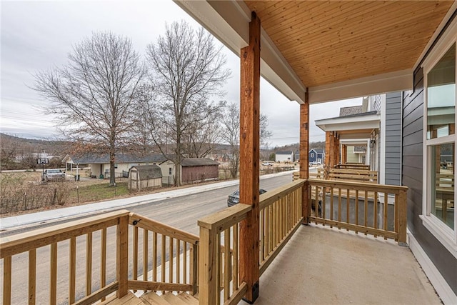 exterior space with covered porch and a residential view