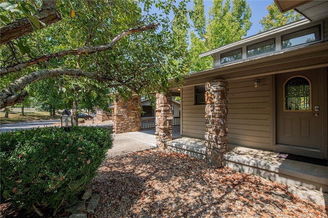 doorway to property featuring covered porch