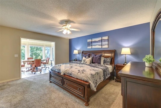 bedroom with a textured ceiling, a ceiling fan, and light carpet