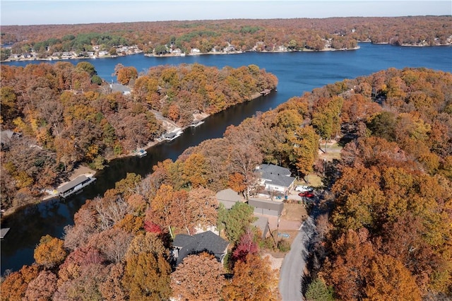 aerial view with a water view and a forest view