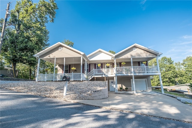 view of front facade with covered porch and a garage