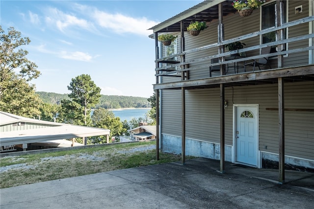 exterior space featuring a water view and a carport