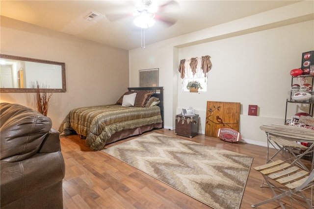 bedroom with ceiling fan and wood-type flooring