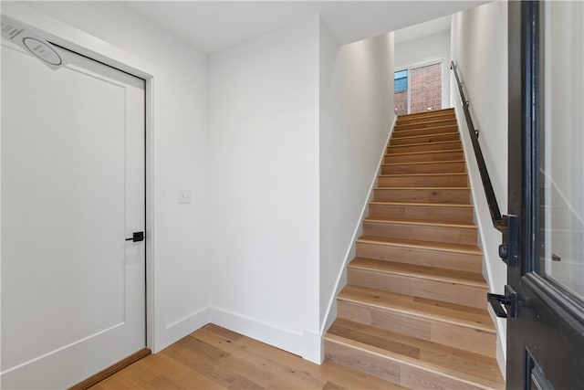 stairway with hardwood / wood-style flooring