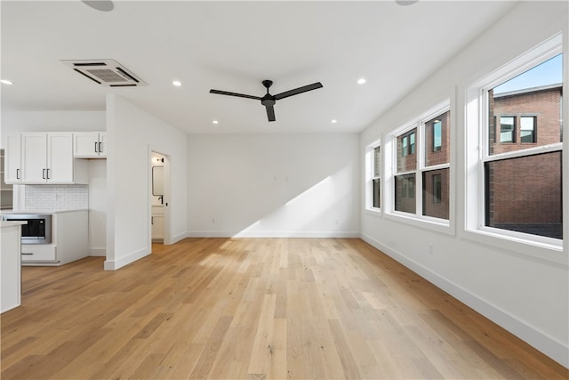 unfurnished living room featuring light hardwood / wood-style flooring and ceiling fan