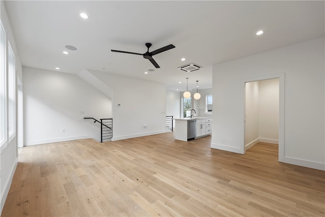 unfurnished living room with ceiling fan, light hardwood / wood-style floors, and sink