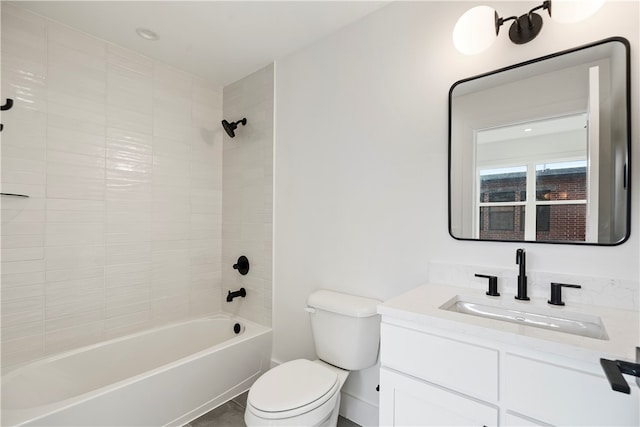 full bathroom with vanity, toilet, and tiled shower / bath