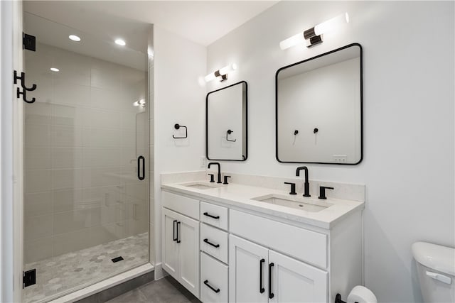 bathroom with vanity, toilet, and walk in shower