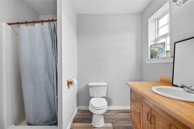 bathroom featuring vanity, toilet, hardwood / wood-style floors, and a shower with shower curtain