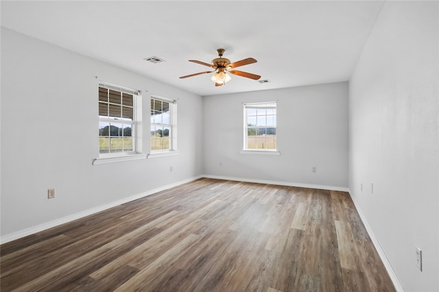 spare room with hardwood / wood-style flooring and ceiling fan