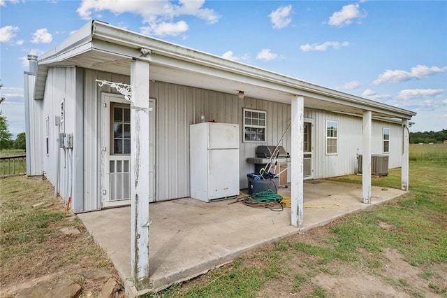 rear view of property featuring a lawn and a patio