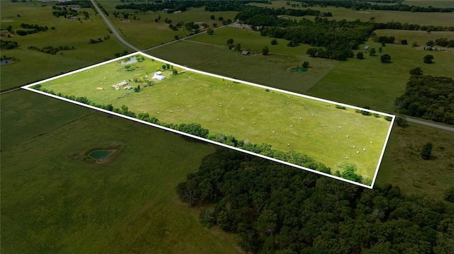 birds eye view of property with a rural view