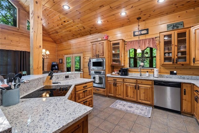 kitchen with a healthy amount of sunlight, hanging light fixtures, stainless steel appliances, and sink