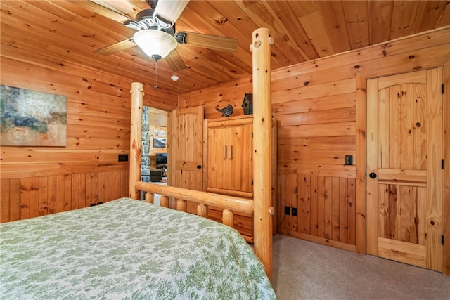 bedroom with wood ceiling, ceiling fan, wooden walls, and carpet flooring