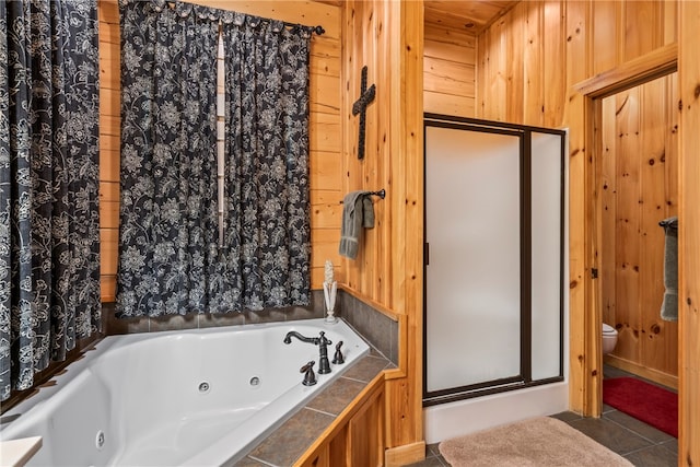 bathroom featuring toilet, wood walls, tile patterned floors, and plus walk in shower