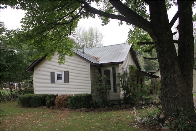 view of side of property with a lawn