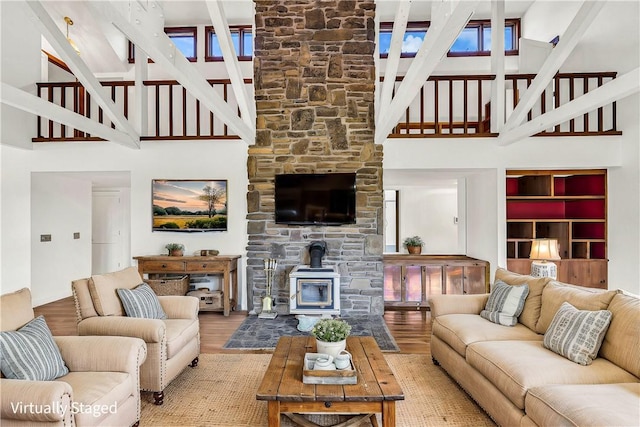 living area featuring wood finished floors and a wood stove