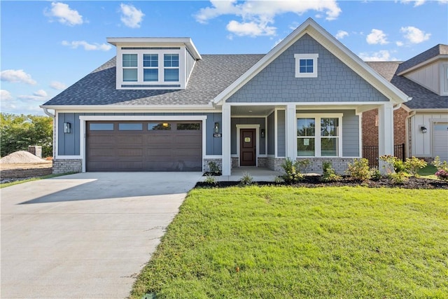 craftsman-style house featuring covered porch and a front lawn