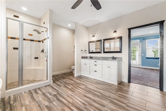 bathroom with vanity, toilet, hardwood / wood-style floors, and a shower with shower door